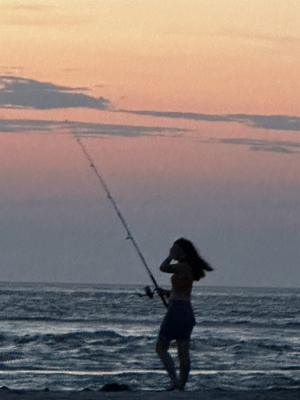 Surf fishing at sunrise on the beach near the house